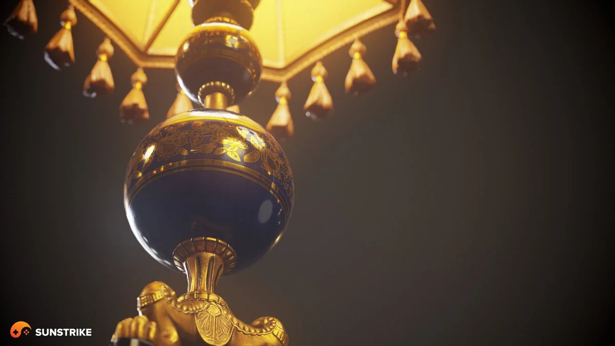 Close-up 3D render of an ornate chandelier - a dark blue porcelain orb with gilded floral detail, gold tassels and a glowing fabric shade