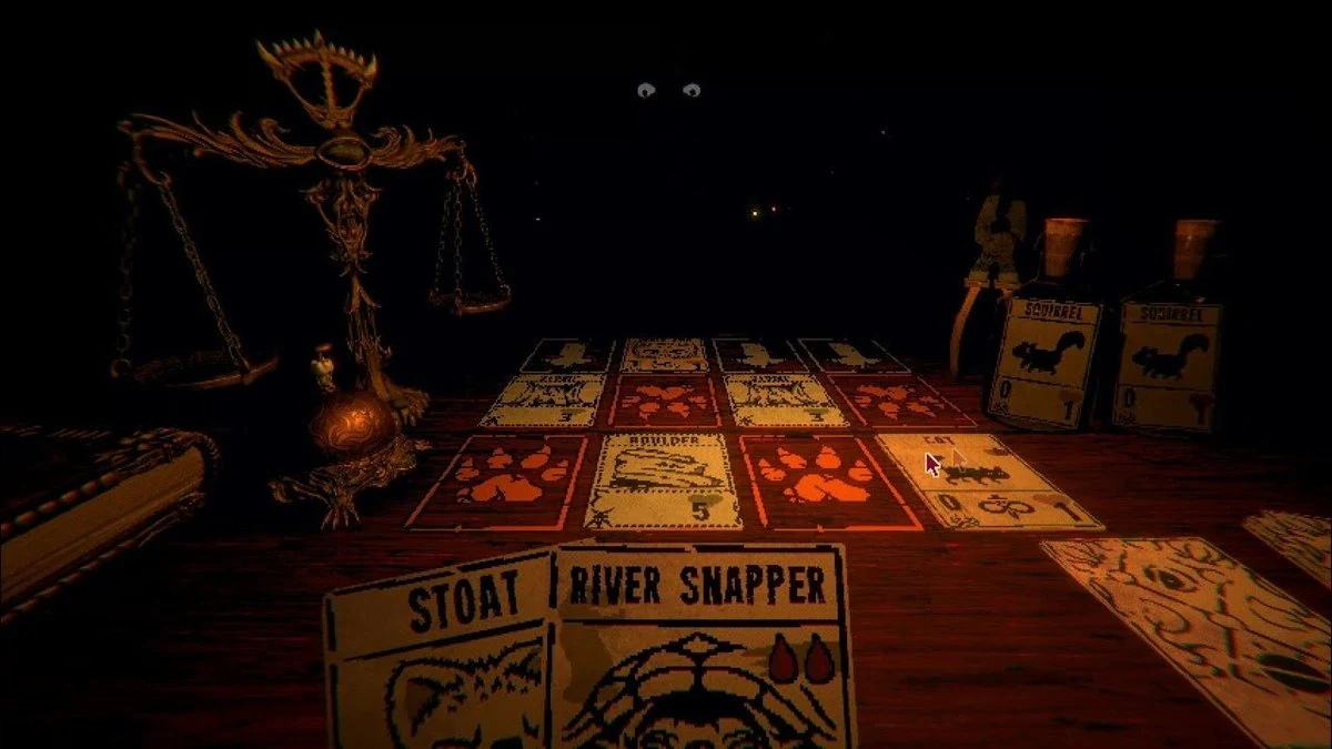 Inscryption candlelit table covered with hand-drawn animal cards beside a brass scale and glowing eyes in the darkness